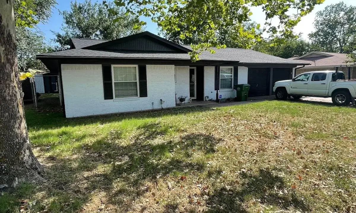 Professional roofing crew working on a residential roof in Alma